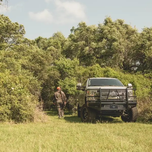 Gun Hunting Pickup Truck in Woods