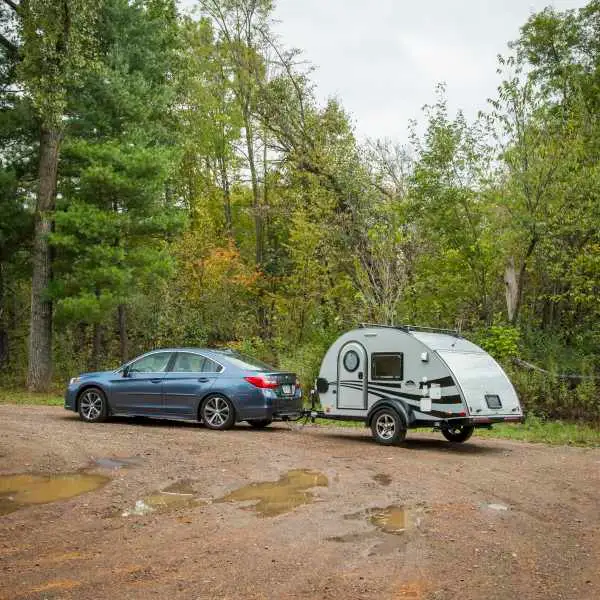 Teardrop camper towed by car