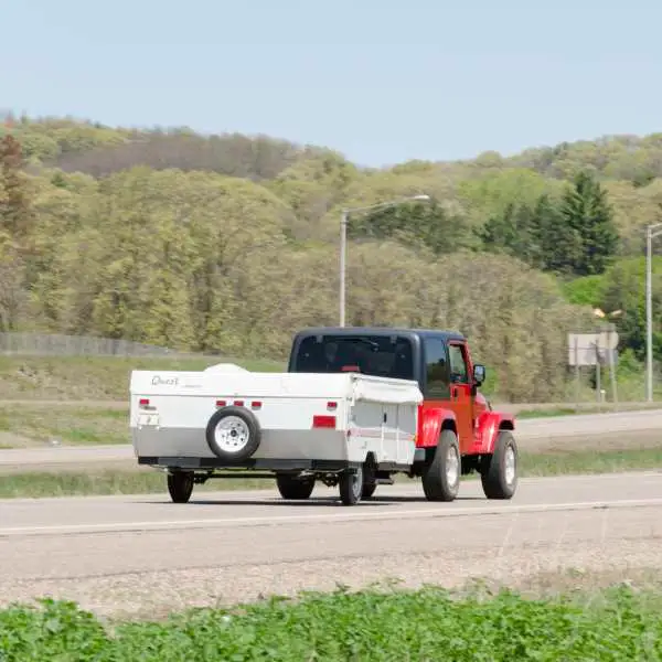 Jeep towing pop-up camper trailer