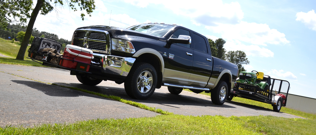 CURT front hitch with cargo carrier on truck towing trailer