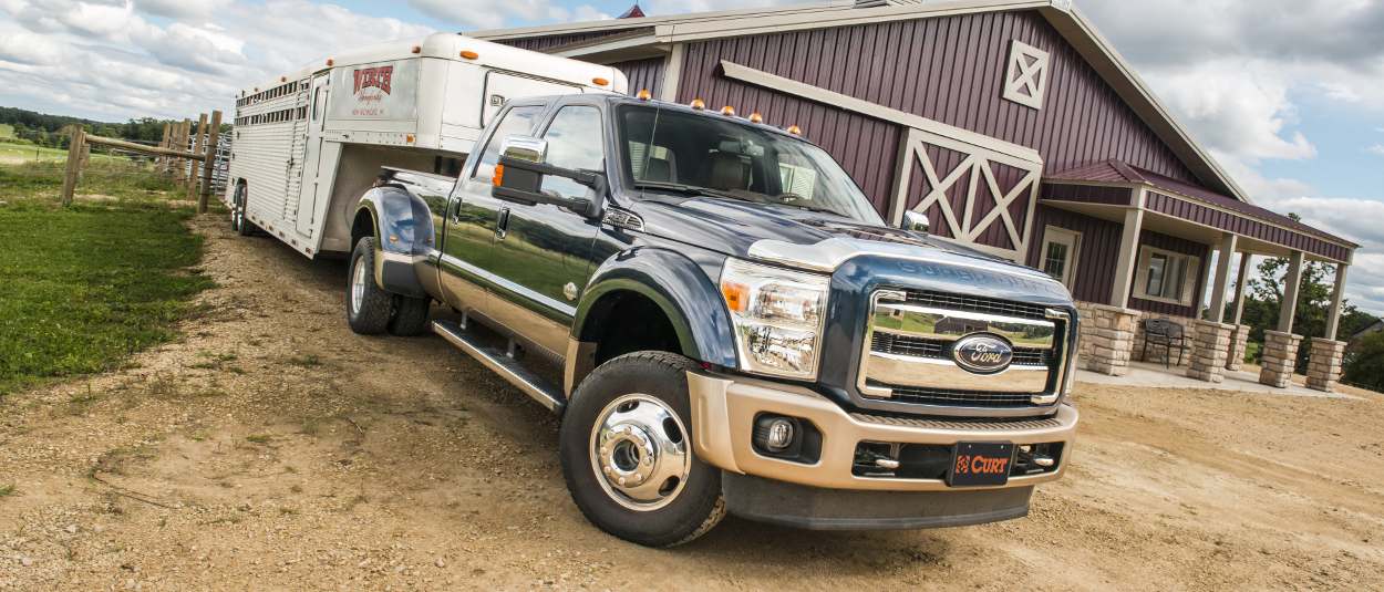 Farm truck towing livestock trailer with CURT gooseneck hitch