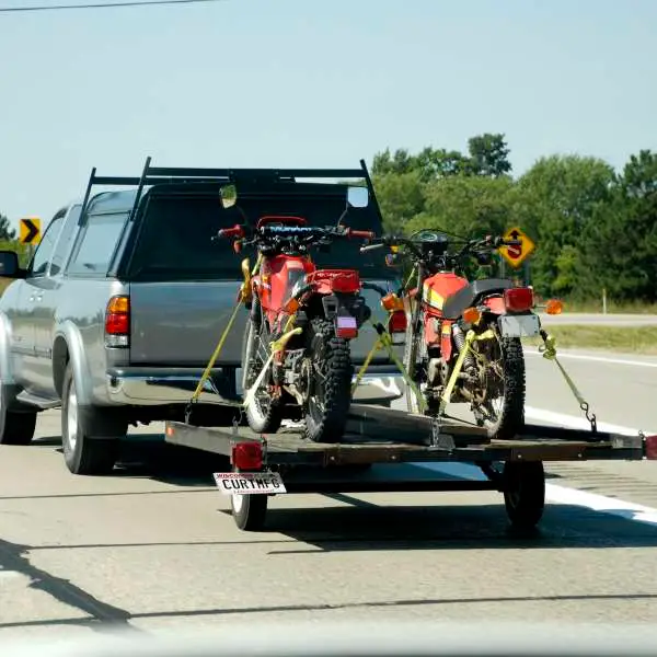 Two motorcycles on flat trailer