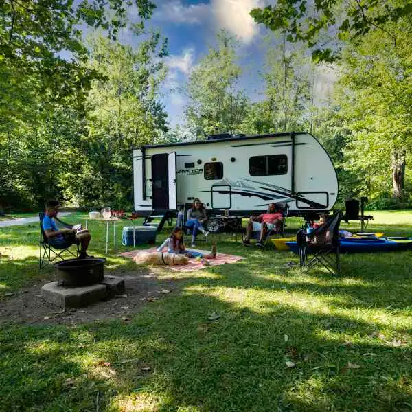 Family enjoying travel trailer camp