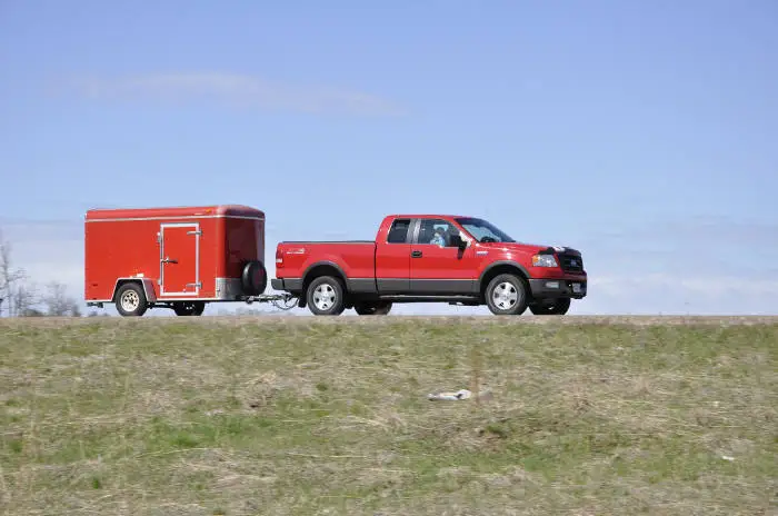 Pickup Truck Towing Small Enclosed Trailer