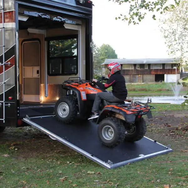 ATV driving up toy hauler ramp