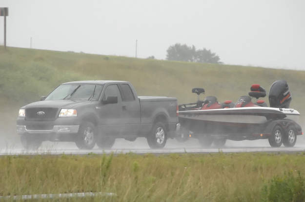 Truck towing boat trailer through rain with CURT custom wiring